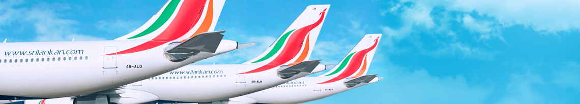 Six SriLankan Airlines flights parked upon the apron with only their tails visible with the logo